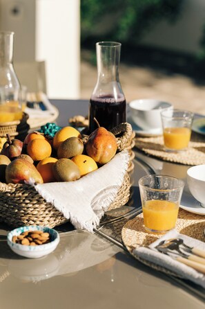 Lifestyle shot featuring a fresh breakfast with juice and fruits.