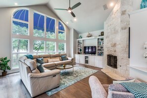 With a delightful air of elegance, this living room offers beautiful views of the backyard and a spacious layout that offers the perfect blend of coziness and luxury.