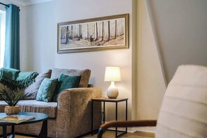 The spacious living space benefits from a comfortable sofa bed, a 40-inch smart TV and plenty of space to sit down and relax.