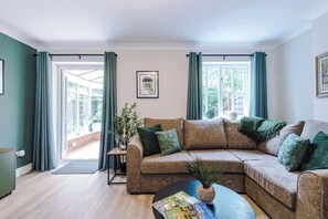 The spacious living space benefits from a comfortable sofa bed, a 40-inch smart TV and plenty of space to sit down and relax.