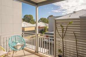 The balcony is a sunny spot to enjoy your morning coffee or unwind in the afternoon with a good book.
