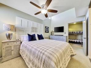 View of the primary bedroom with ceiling fan, night stands and lamps