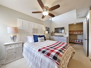 View of the primary bedroom with ceiling fan, night stands and lamps
