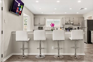 Gather around the dining table or enjoy a drink at the wet bar with bar stools.