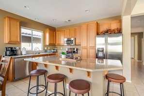 Fully stocked kitchen with Barstool seating good for 2.