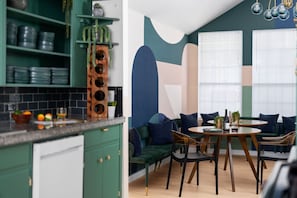 Gather around this artful corner with bold design, plush seating, and great vibes for shared meals or morning coffee.