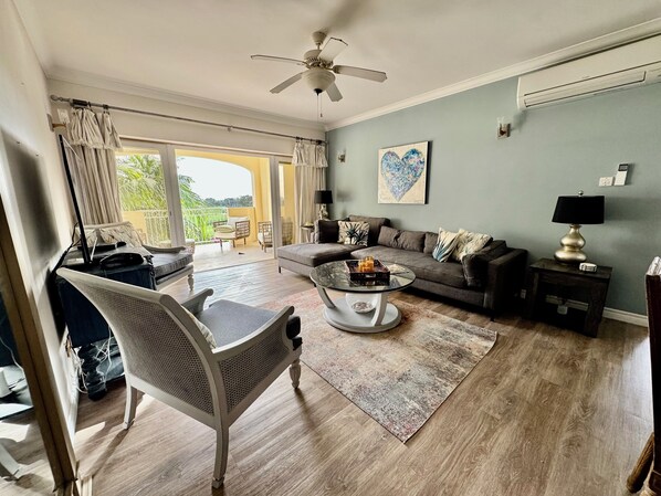 Spacious Living room looking out to the terrace, with AC and streaming TV, Cable