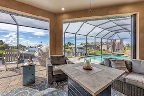 Large outdoor living space with sparkling, private pool & spa overlooking the water