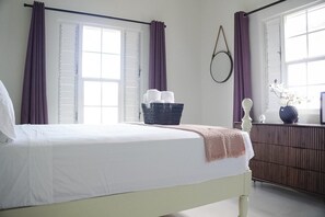 This room has a queen-sized bed and is decorated in calming colours.