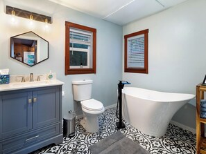 Main floor bathroom features a lovely soaking tub.