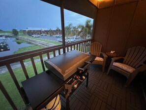 Relax on the screened-in back porch, complete with a brand-new Blackstone grill 