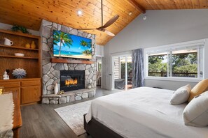 The primary bedroom (main level) - a touch of romance, gorgeous views and a cozy fireplace