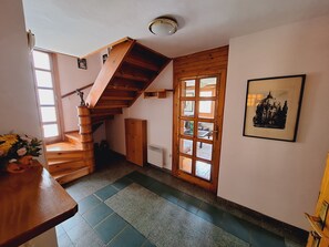 Vintage wooden staircase connecting the two floors of the apartment. 