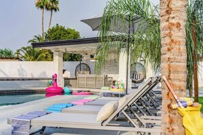 Lounge chairs, floaties, outdoor seating with TV!