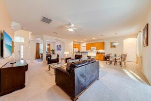 Open-plan lounge, leading to kitchen and pool deck