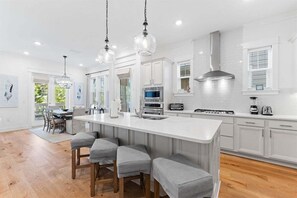Enjoy a spacious kitchen with sleek finishes and a breezy coastal vibe.