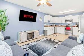 A modern living room with sofa and Netflix TV for entertainment and relaxation!