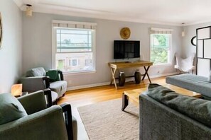 Peaceful living room with new pullout sofa and twin bed
