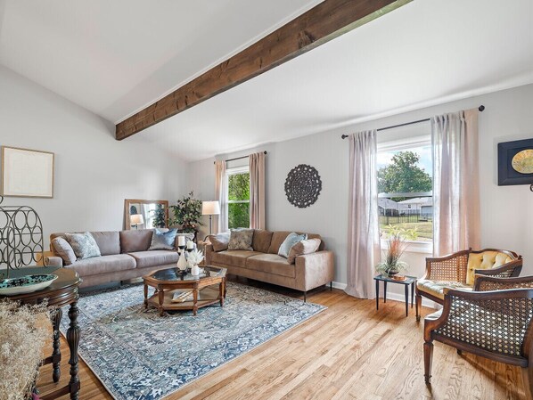 Cozy vibes and wooden highs! This living room is a dream come true with those stunning beams above and hardwood beneath. 🌟 #HomeSweetHome