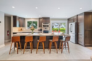 Open Living room with outdoor pool and vineyard views.