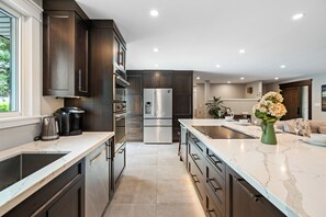 Full Custom Kitchen featuring Induction Cook Top and Open Concept Island seating