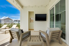 Outdoor lounge space with pool bath and Smart TV