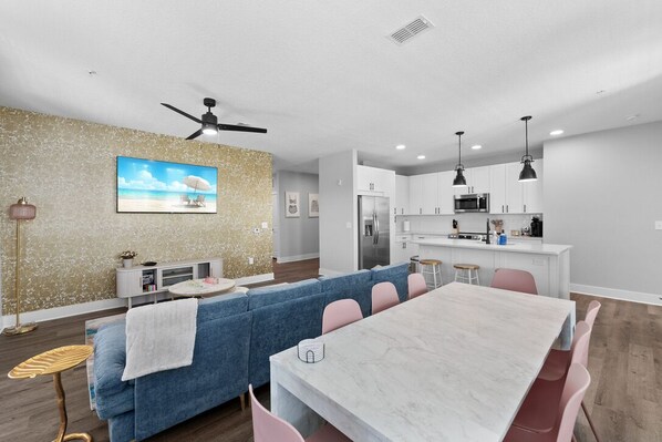 A stylish and open-concept living and dining space with a modern design aesthetic