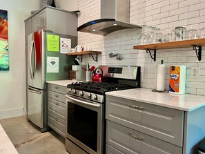 The full kitchen includes a gas range, full size refrigerator, and Keurig coffee maker.