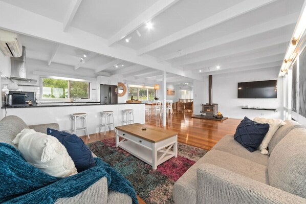 Open plan lounge with wood fire burner & Air-conditioning.