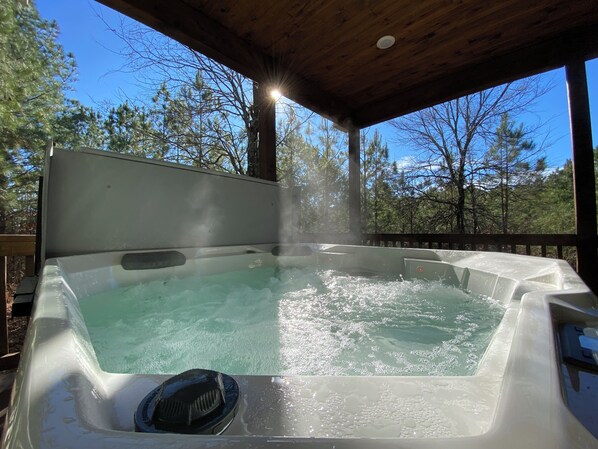 Hot tub under canopy with forest views—your perfect serene escape