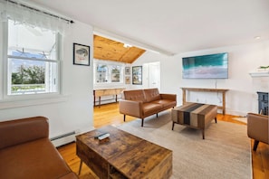 Spacious living room with 2 futon couches (each able to sleep 1 person), comfortable chair, and Roku smart TV - note: fireplace is inoperable