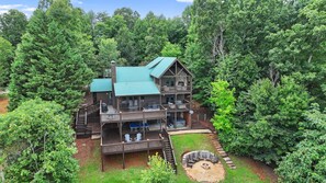 An aerial perspective reveals the stunning architecture of our cabin and its inviting outdoor spaces, including the decks and firepit