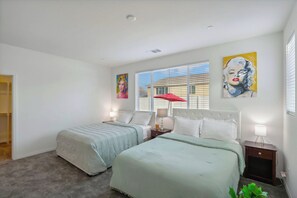 Master bedroom featuring an en-suite bathroom and a spacious walk-in closet.