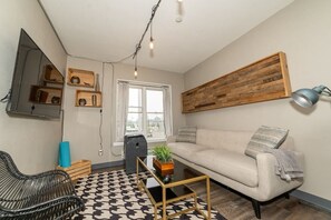 Beautiful living room with tall windows overlooking downtown.