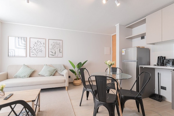 Cozy living area with modern amenities and stylish decor, perfect for relaxing and dining in comfort.