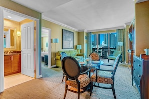 Spacious living area with queen sofa bed and direct balcony access.