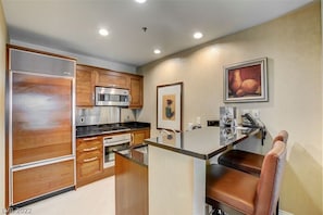 Full kitchen with cooktop, fridge, oven, and dining for 6 — perfect for longer stays.