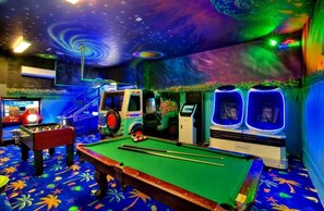 Experience cinematic luxury in our state-of-the-art game room with arcades, pool table, foosball