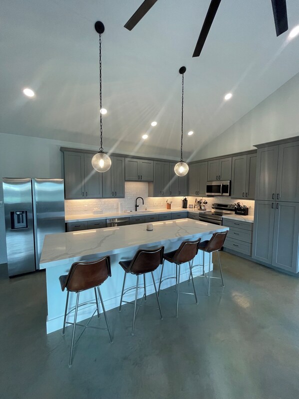 Full kitchen with bar seating for four