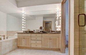 Pamper yourself in the luxurious bathroom, complete with a large vanity, well-lit mirror, and elegant fixtures for a spa-like experience.