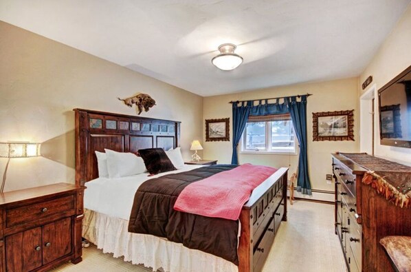 Relax in the cozy bedroom featuring a comfortable queen-sized bed, soft linens, and a private balcony offering a tranquil view, perfect for morning coffee or evening relaxation.