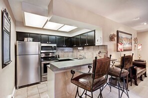 Cook up a storm in the fully-equipped modern kitchen, boasting stainless steel appliances, ample counter space, and a charming dining area ideal for family meals.