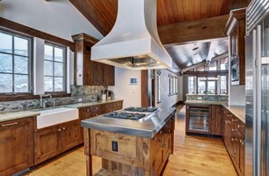 Channel your inner chef in the gourmet kitchen, equipped with high-end appliances, granite countertops, and a spacious layout perfect for preparing delicious meals.
