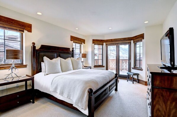 Sleep in luxury in the master bedroom, featuring a plush bed, elegant furnishings, and expansive windows that fill the room with natural light.