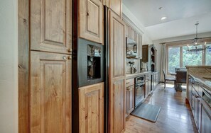 Prepare meals in the well-equipped kitchen, boasting plenty of storage, high-end appliances, and a bright, airy atmosphere.