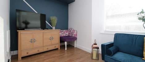 Whether you're catching up on work, spending a quiet evening in, or sharing the space with a loved one, the relaxed atmosphere and stylish touches make this living area a truly welcoming spot.
