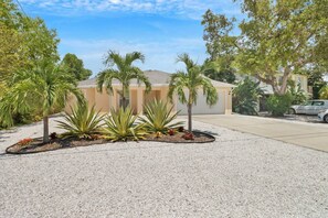 The exterior "beachy vibes" of the home are ready to welcome you when you arrive.