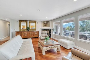Comfortable main level family room with view windows of the mountains and city lights.