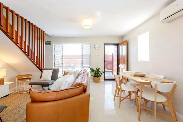 Cosy open plan living/dining area opens onto the outside courtyard.