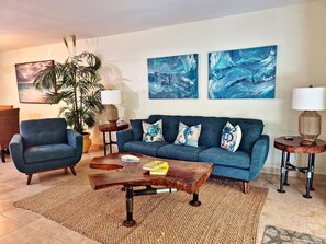 Comfy sofa and lounge chair with our very own local artist made wall art, coffee table and end tables! a great place to relax after a day of adventures on Singer Island. Enjoy the Island life!
